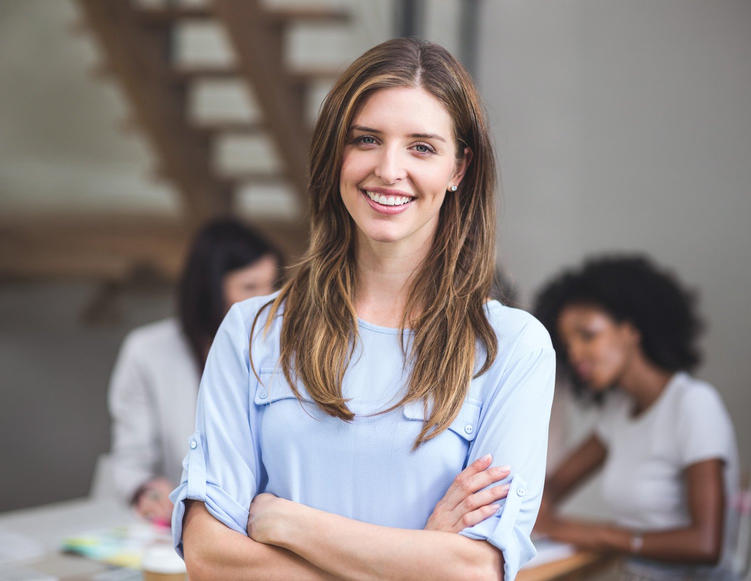 portrait-businesswoman-standing-with-arms-crossed-mobile